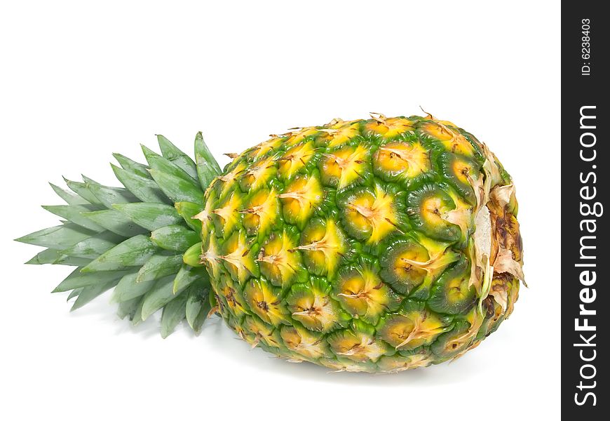 One whole pineapple isolated on a white background.