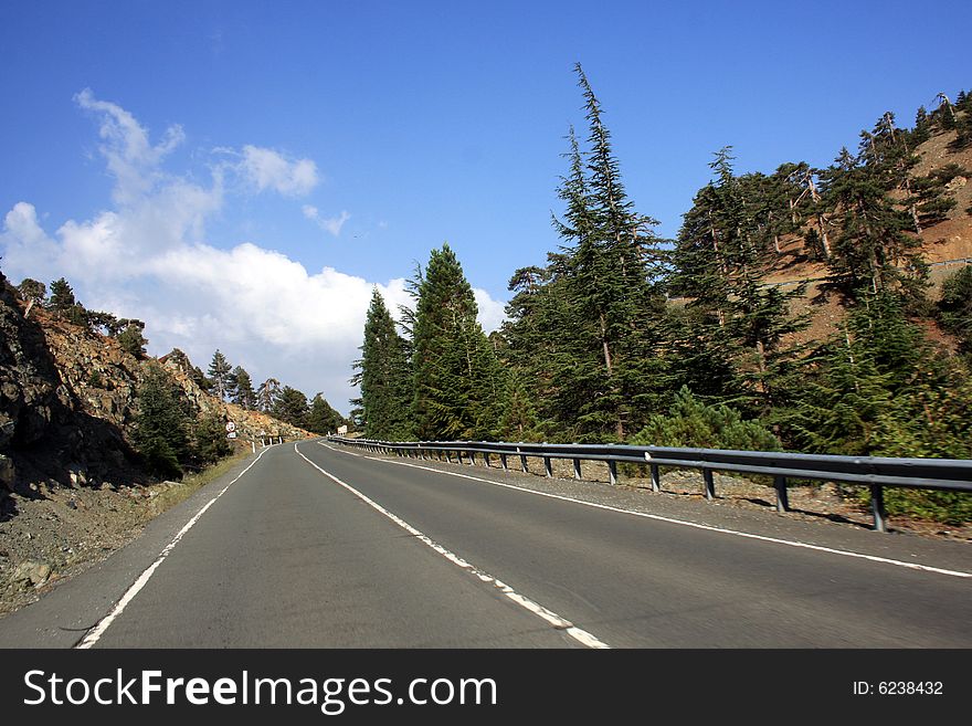 Two-Lane Paved Mountain Road with Blue Sky