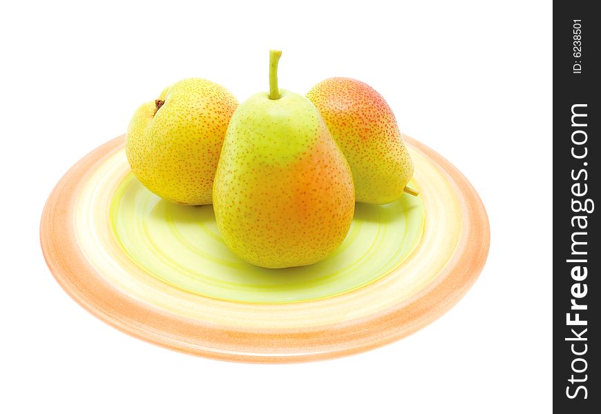 Three green pears on a  plate over white.