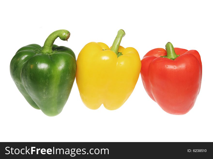 Green yellow and red bell peppers isolated on white