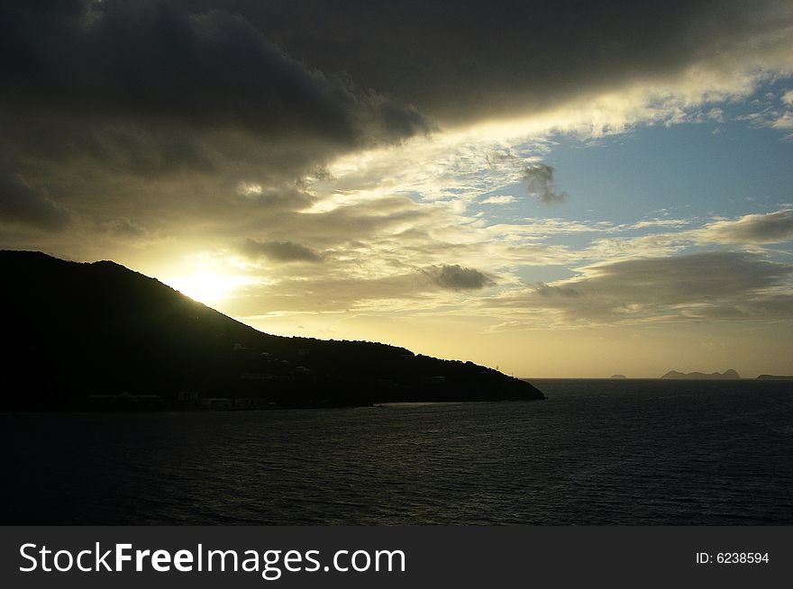 The sunrise over Tortola island with Virgin Gorda island in a background (British Virgin Islands). The sunrise over Tortola island with Virgin Gorda island in a background (British Virgin Islands).