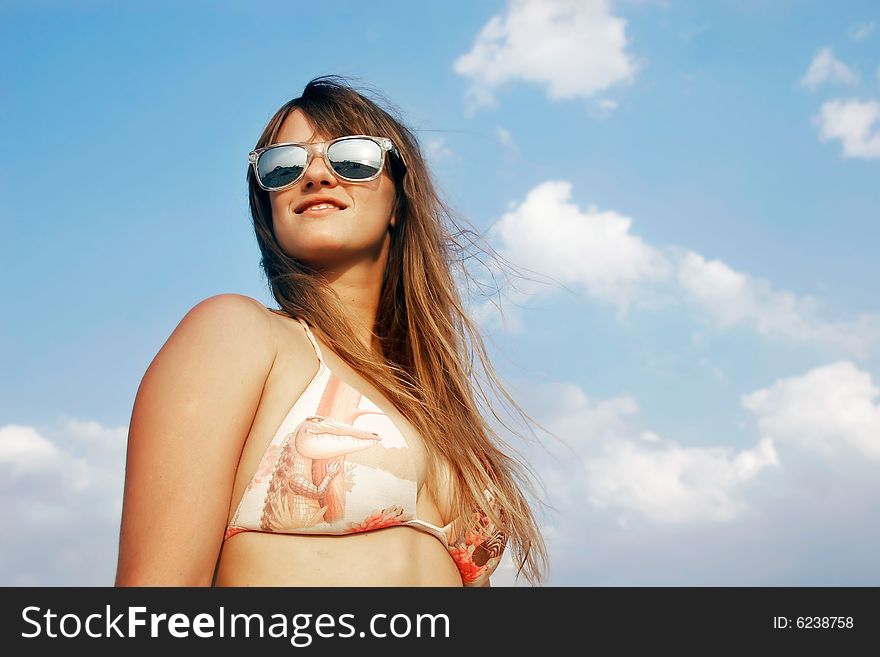 Beautiful girl over sky background