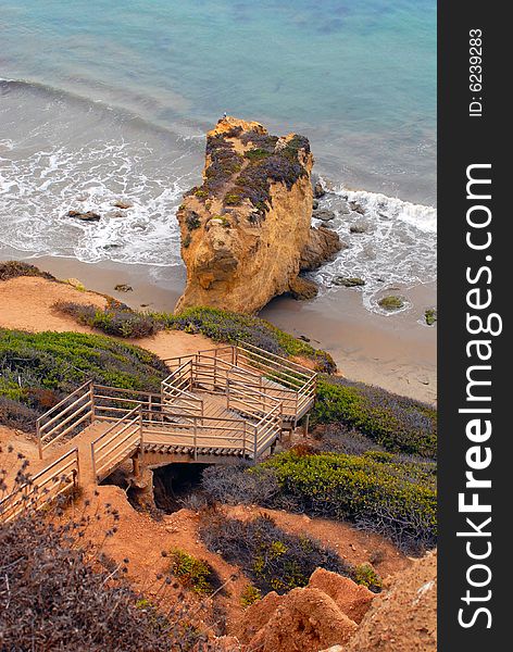 Stairs down a cliff leading to beach. Stairs down a cliff leading to beach