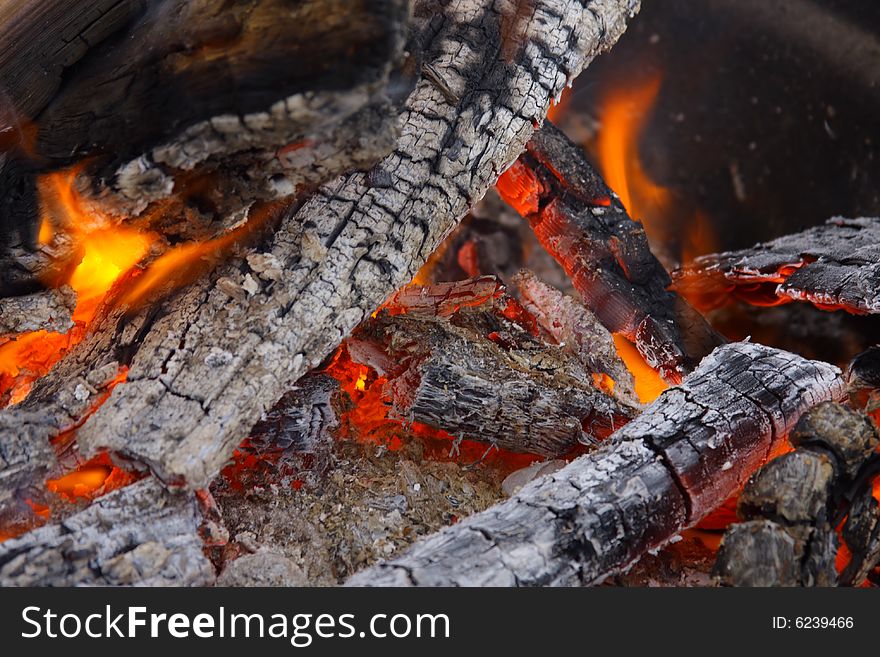 Campfire wood fire burning with charred coals. Campfire wood fire burning with charred coals.