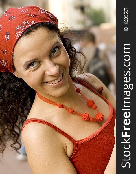 Outdoor portrait of happy woman in red