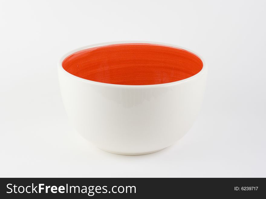 Red and white bowl on a white background