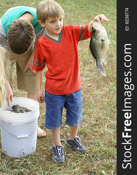 Shot of a young boy showing off his catch