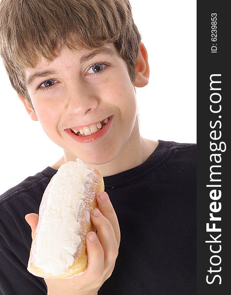 Young boy eating a doughnut isolated on white