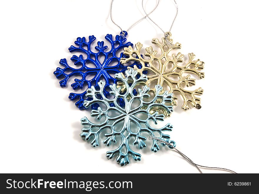 Multicolored snowflake shaped Christmas decorations. Multicolored snowflake shaped Christmas decorations