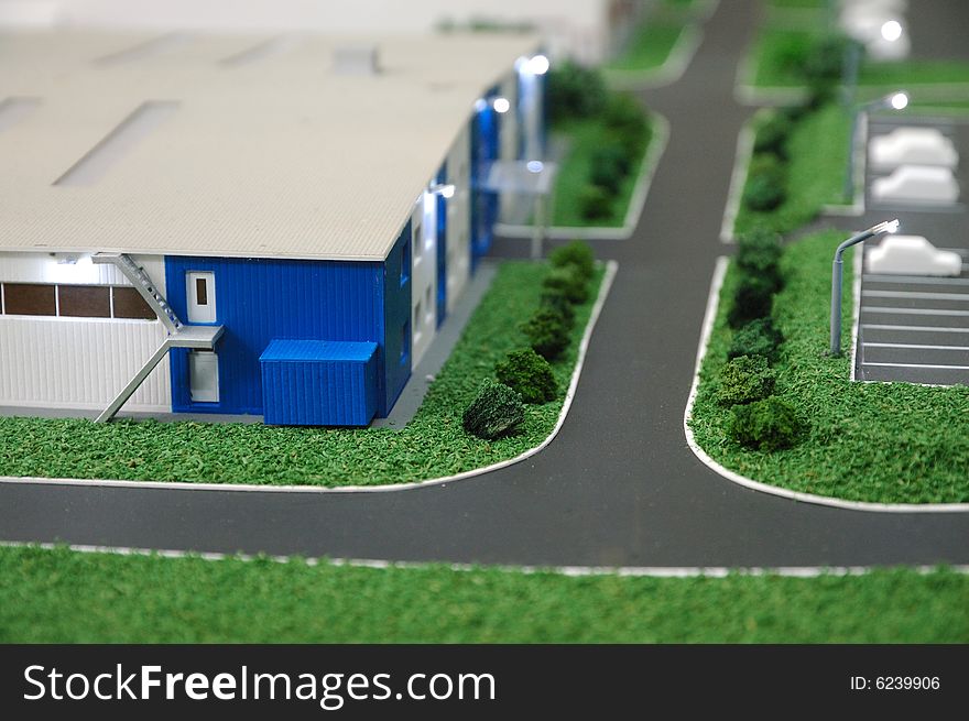 Prototype of modern warehouse with parking and cars