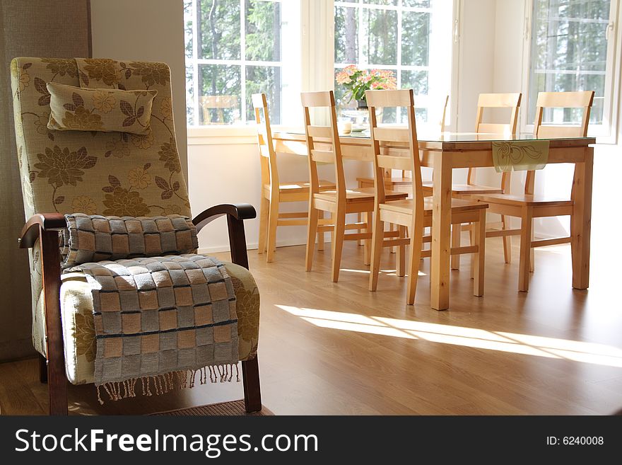 Interior of a home, armchair and dining room. Interior of a home, armchair and dining room