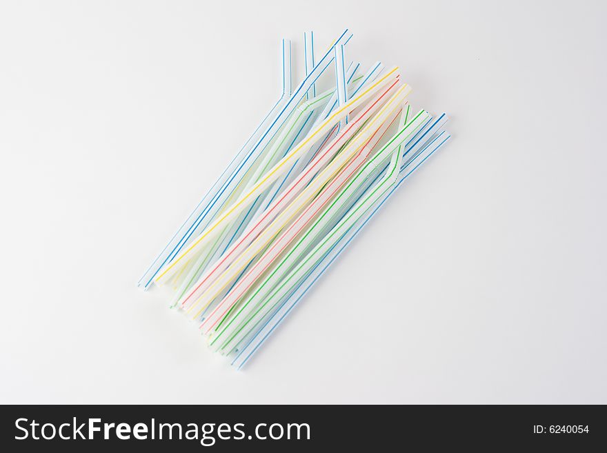 A bundle of colored straws on a white background. A bundle of colored straws on a white background