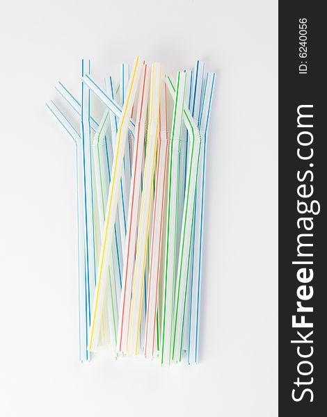 A bundle of colored straws on a white background. A bundle of colored straws on a white background
