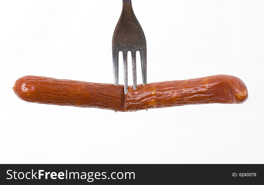 Sausage on a fork on white background