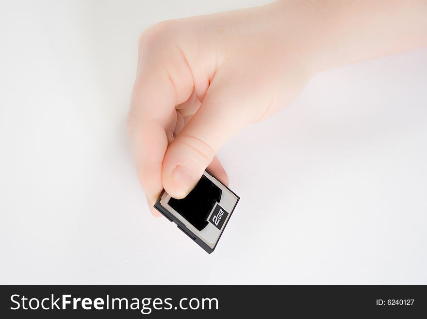 Hand holding a memory card against a white background. Hand holding a memory card against a white background