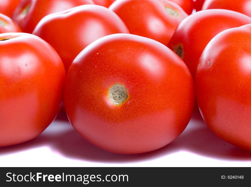 Close-up many ripe tomatoes, isolated on white