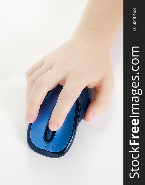 Hand with a computer mouse against a white background top down. Hand with a computer mouse against a white background top down