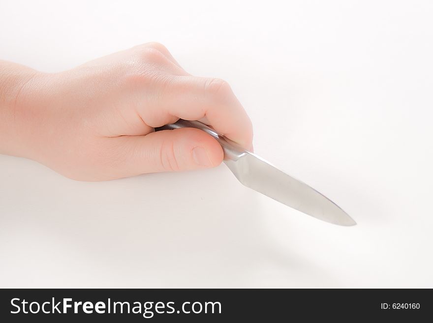 A hand holding a knife against a white background