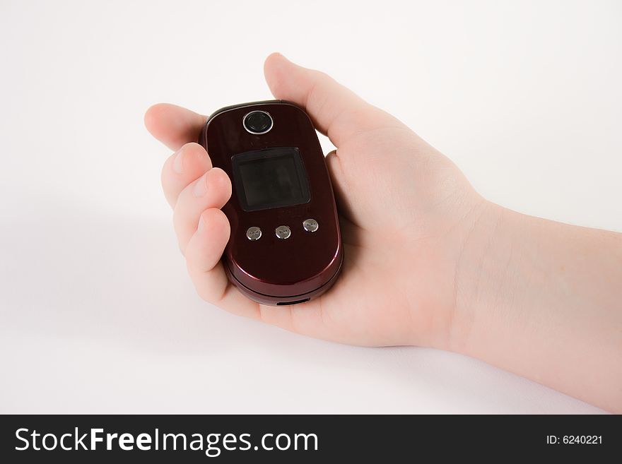 Hand holding a cell phone against a white background