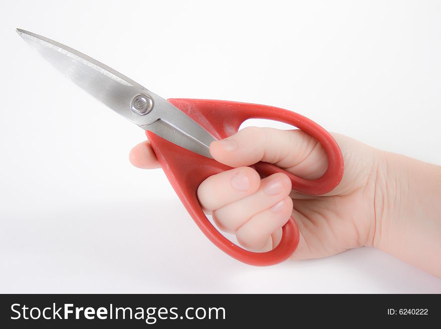 Woman holding scissors against a white background