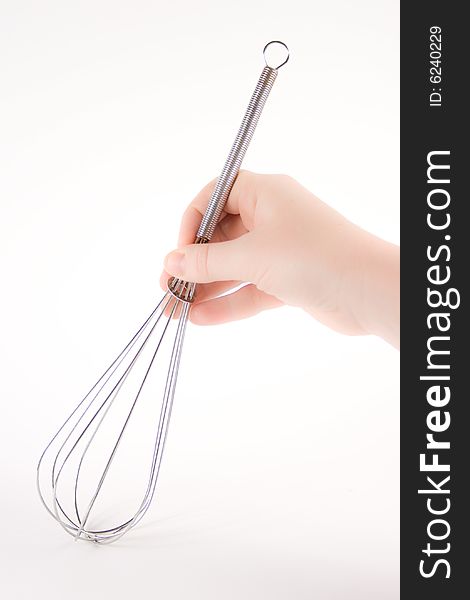 A woman's hand holding a whisk with a white background