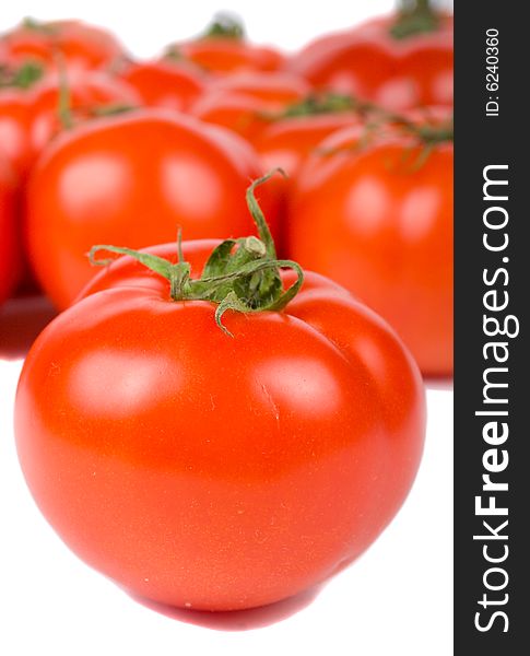 Close-up ripe tomato on tomatoes background, isolated on white