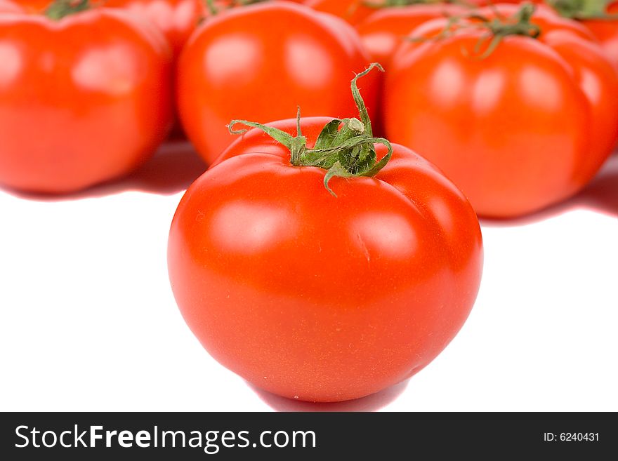 Close-up tomato on tomatoes background, isolated on white