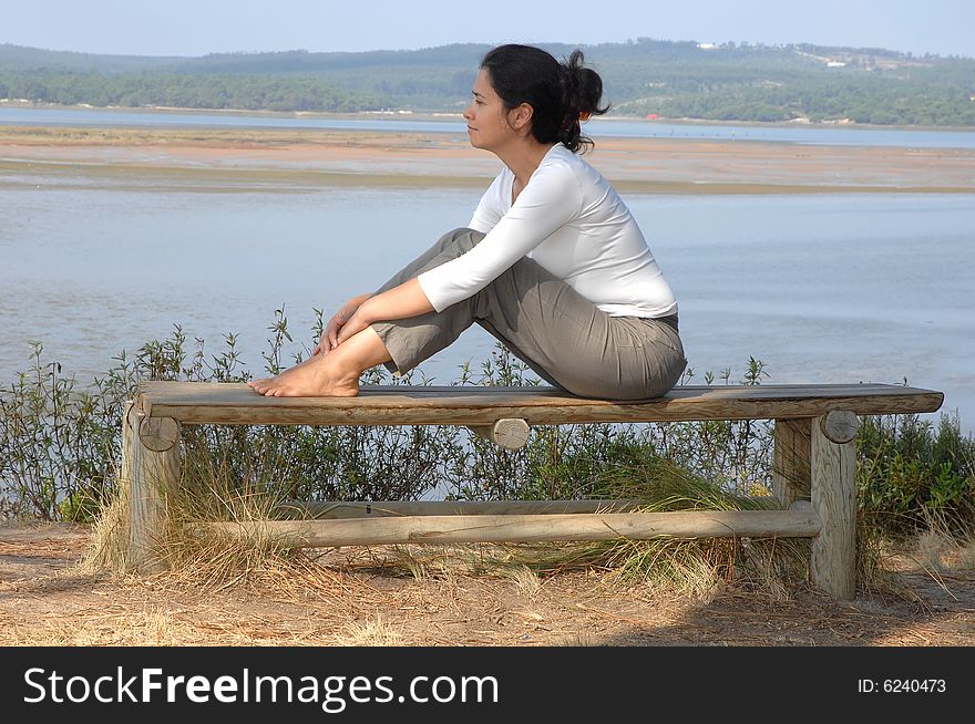 Woman Sitting On A Park
