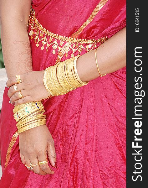 A bride's hand with all sorts of gold jewels. A bride's hand with all sorts of gold jewels.