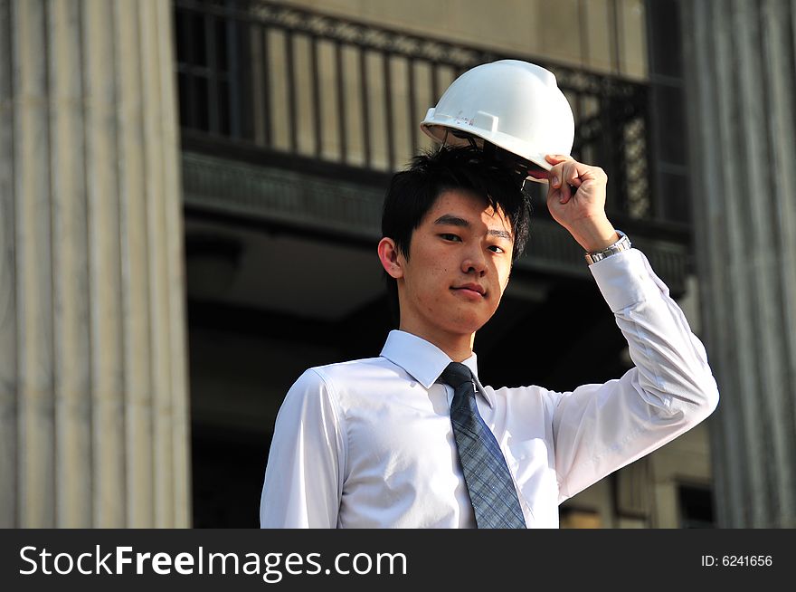 Picture of Asian Guy. Suitable for Job Search, Career Guidance context. He is pictured with an Engineer's hard hat. Picture of Asian Guy. Suitable for Job Search, Career Guidance context. He is pictured with an Engineer's hard hat