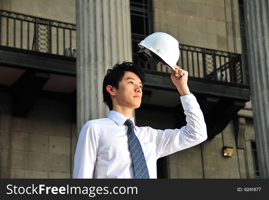 Picture of Asian Guy. Suitable for Job Search, Career Guidance context. He is pictured with an Engineer's hard hat. Picture of Asian Guy. Suitable for Job Search, Career Guidance context. He is pictured with an Engineer's hard hat