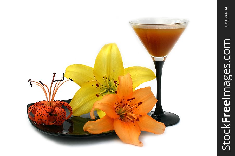 Transparent wineglass with peach juice and flowers