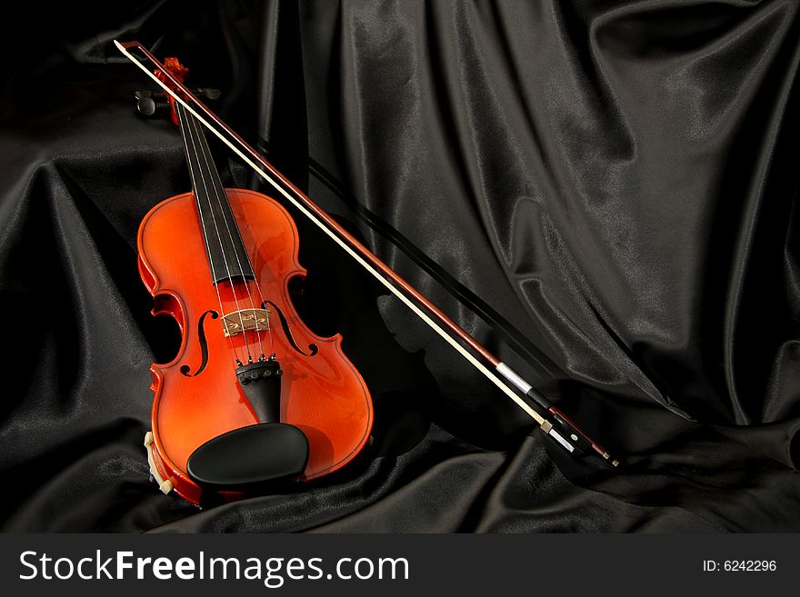 Violin And Bow On Black Silk