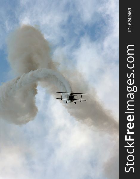 Acrobatic plane in action during airshow maneuvers. Acrobatic plane in action during airshow maneuvers