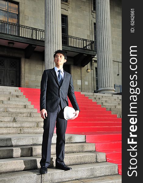 Picture of Asian Guy. Suitable for Job Search, Career Guidance context. He is pictured with an Engineer's hard hat. Picture of Asian Guy. Suitable for Job Search, Career Guidance context. He is pictured with an Engineer's hard hat