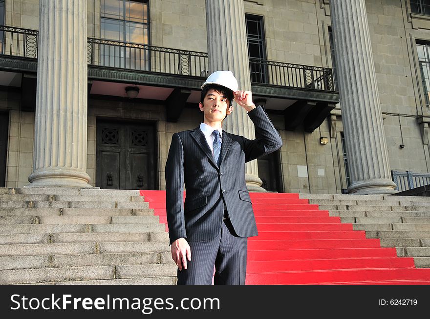Picture of Asian Guy. Suitable for Job Search, Career Guidance context. He is pictured with an Engineer's hard hat. Picture of Asian Guy. Suitable for Job Search, Career Guidance context. He is pictured with an Engineer's hard hat