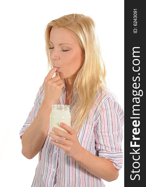 Young woman eating and enjoying yoghurt. Isolated on white background. Young woman eating and enjoying yoghurt. Isolated on white background.