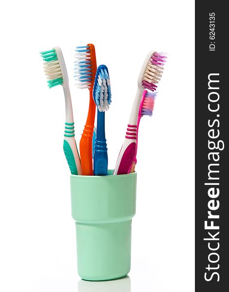Tooth brushes in glass on a white background. Tooth brushes in glass on a white background