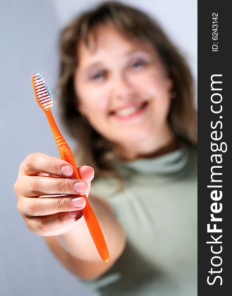Portrait of young female holding yellow toothbrush. Portrait of young female holding yellow toothbrush.