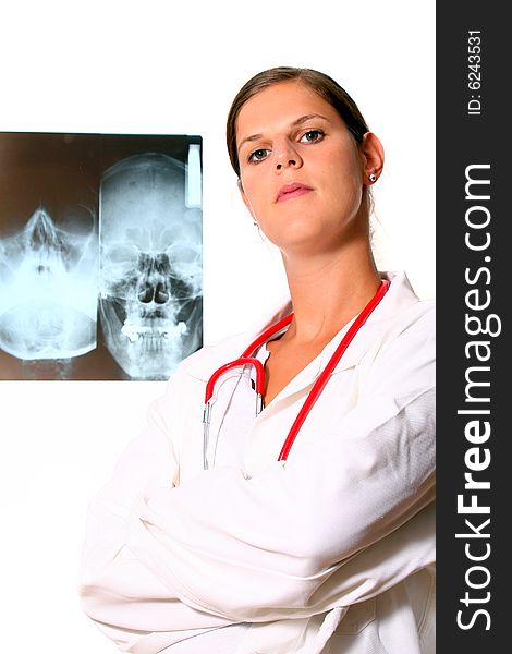 A young female doctor with a x-ray in the background and a stethoscope around the neck! Isolated over white. A young female doctor with a x-ray in the background and a stethoscope around the neck! Isolated over white.