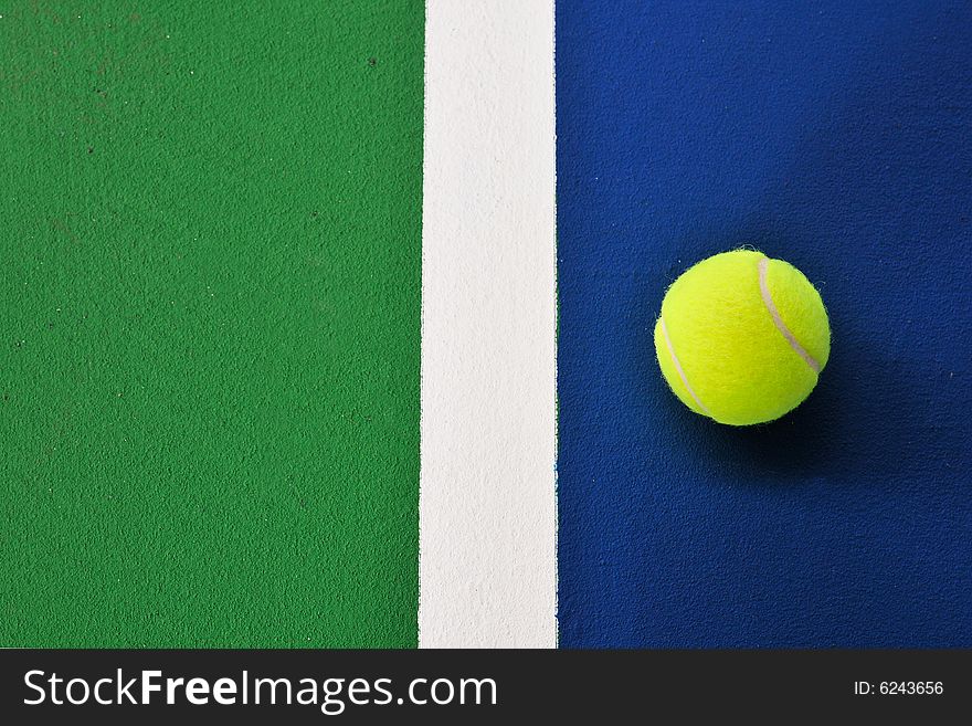 Tennis ball just on the white  line. Tennis ball just on the white  line