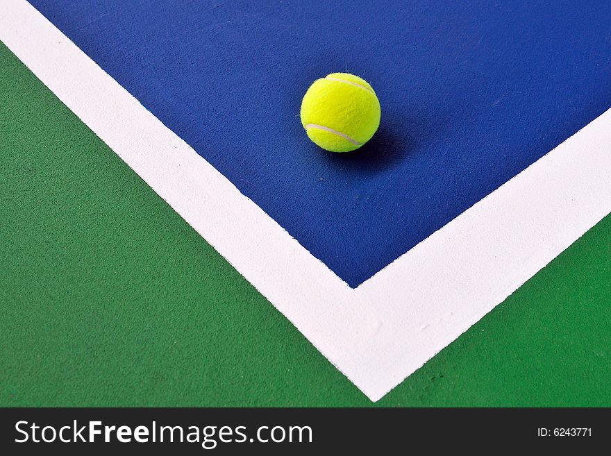 Tennis ball just on the white  line. Tennis ball just on the white  line