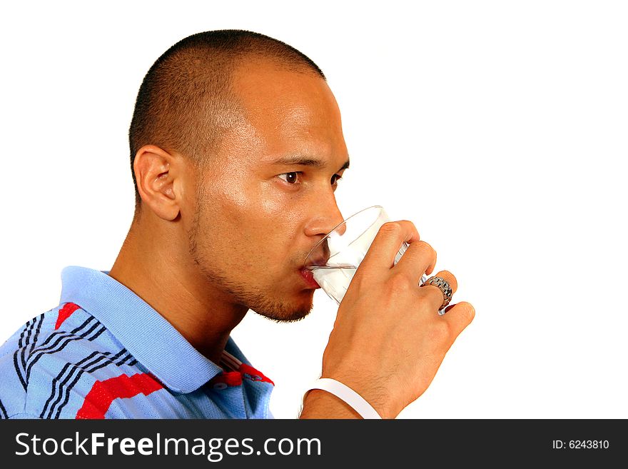 A young man drinking water out of a glass. Isolated over white.