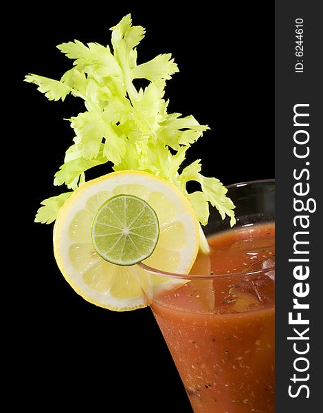 Closeup of a bloody mary cocktail isolated on a black background. Closeup of a bloody mary cocktail isolated on a black background