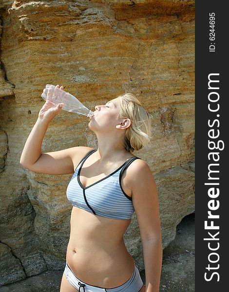 Young beautiful woman drinks water