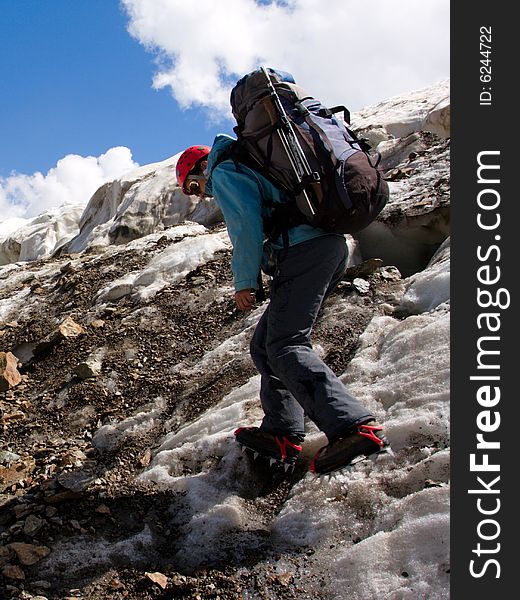 Climber girl in crampon with backpack