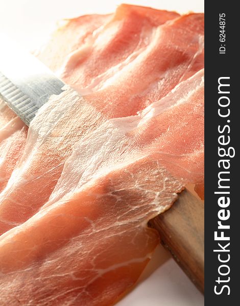 Ham and knife on the white background