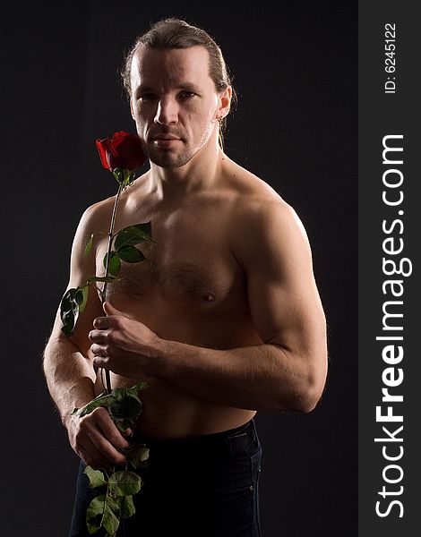 Standing romantic man with red rose. Standing romantic man with red rose