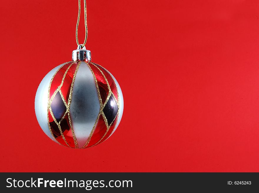 Decorations for the Christmas tree brightly lit on red background. Decorations for the Christmas tree brightly lit on red background