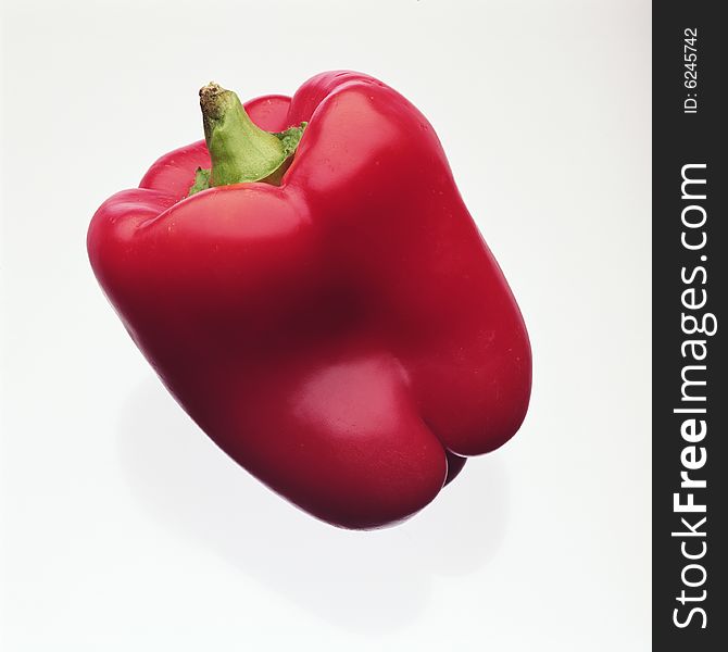 Red sweet ripe pepper on a white background